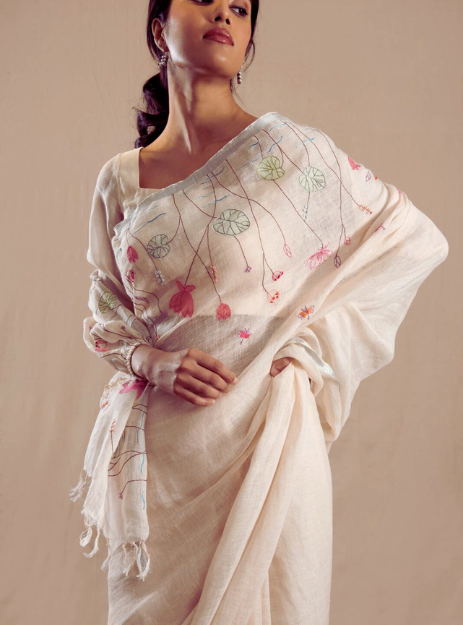 Mridula- off-white pure linen saree adorned with soft pastel thread hand embroidery.